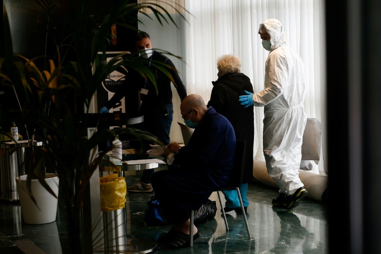 Upon arrival at Barcelona's Hotel Melia Sarria, COVID-19 patients are welcomed not by bellhops, but by a team of nurses wearing green or blue gowns, gloves and face masks