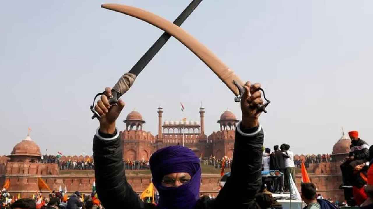 File Photo: A farmer holds a sword during a protest against farm laws introduced by the government, at the historic Red Fort in Delhi, India, Jan 26, 2021. (Photo: REUTERS)